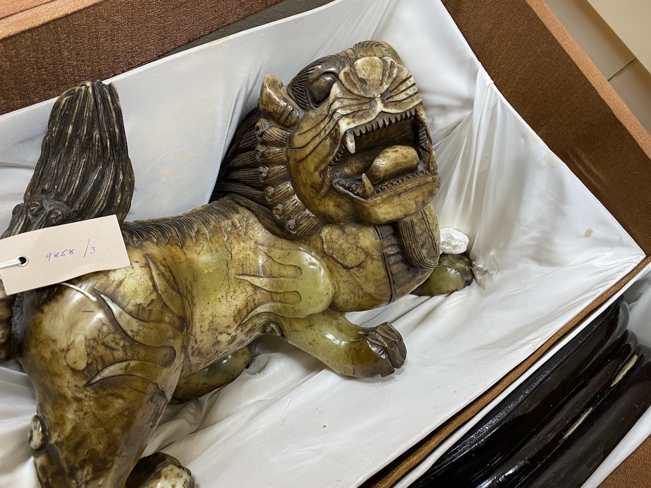 A massive Chinese soapstone figure of a lion-dog, 43cm wide (excl. stand), boxed